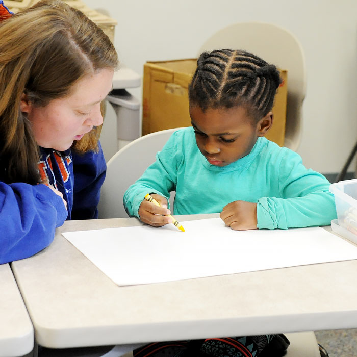 A child writing at a desk A child writing at a desk