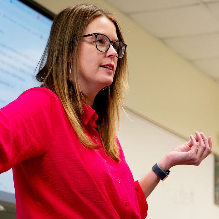 A professor speaking to a class. A professor speaking to a class.