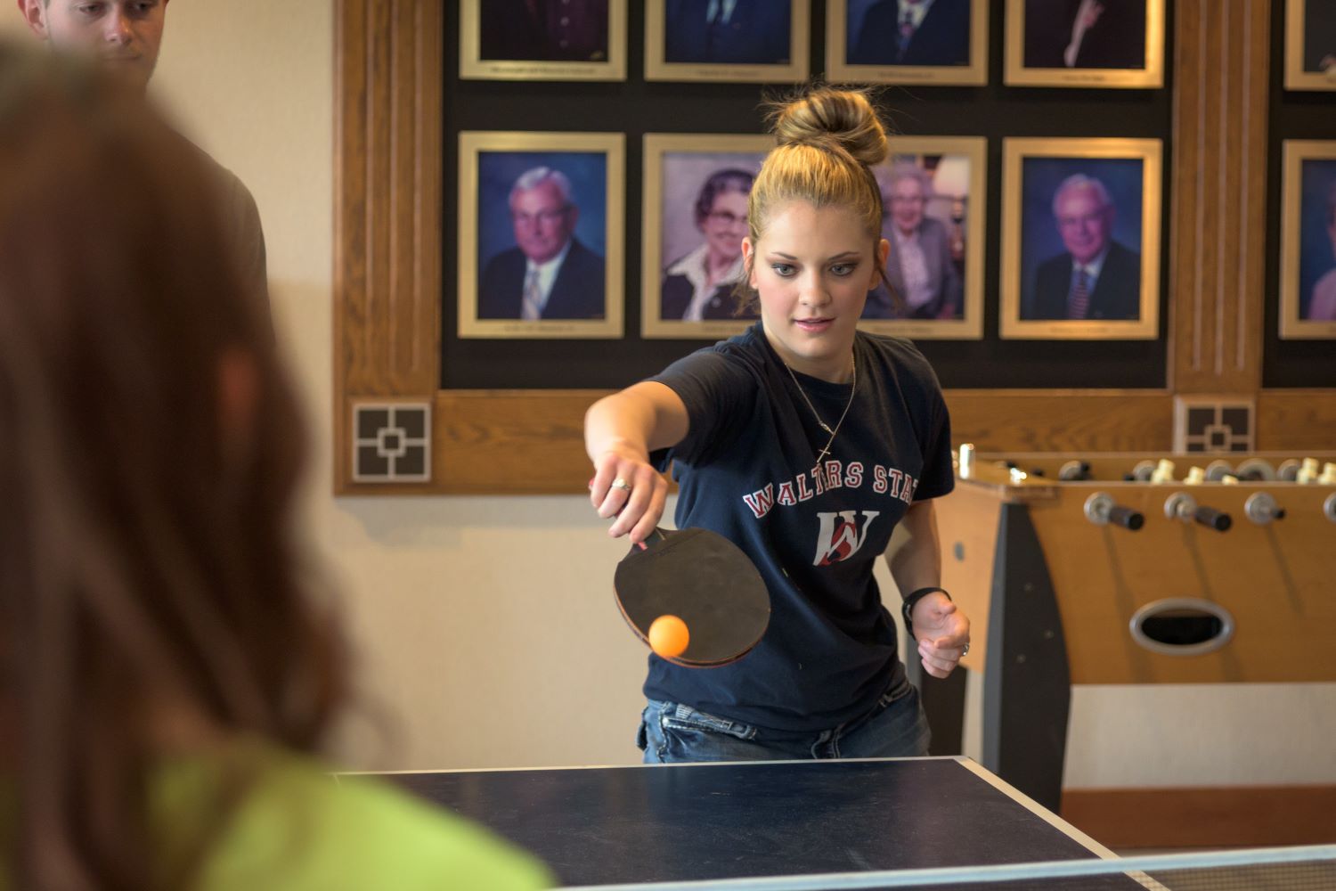 A person playing ping pong in the Sevier County Campus game room